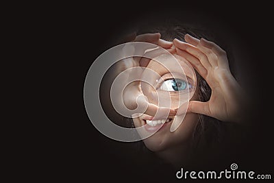 Female eye looking through magnifying glass close up Stock Photo