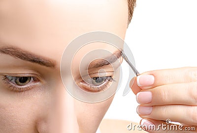 Female eyebrow shape brown eye eyebrow tweezers Stock Photo