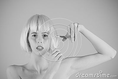 Female Face. Issues affecting girls. Woman in wig on pink background. Stock Photo