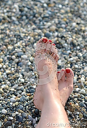 Female feet on the beach Stock Photo