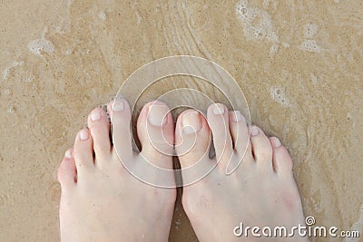 Female feet in the sand. Stock Photo