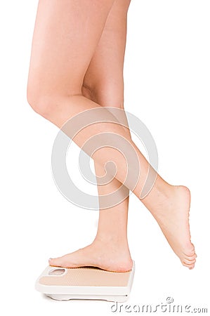 Female feet on scales isolated Stock Photo