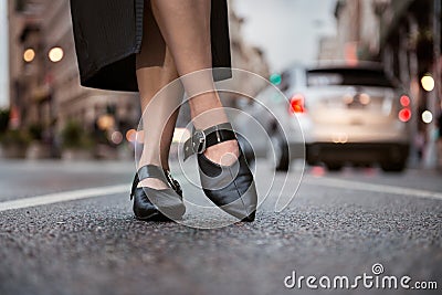 Female feet wear elegant leather shoes. Woman feet wearing high-heels on city street Stock Photo