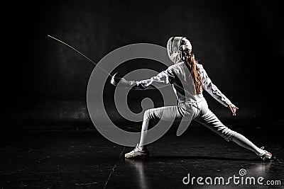 Female fencer on black background Stock Photo