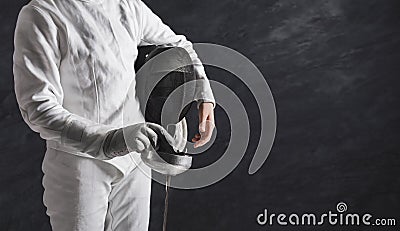 Female fencer in white fencing suit at black background Stock Photo