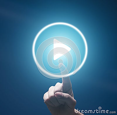 Female finger pushing transparent play button on blue Stock Photo