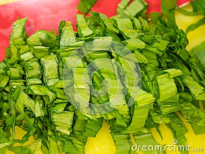 Female fingers cut carefully herb leaves on cutting board. Creating green herbs Stock Photo