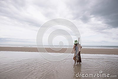 Female fishermen looking for shellfish Editorial Stock Photo