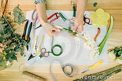 Florist hands doing flower composition, top view Stock Photo