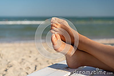 Female foot with hallux valgus close up on the beach Stock Photo