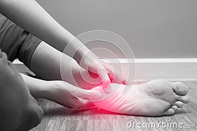 Female foot heel pain with red spot, plantar fasciitis Stock Photo