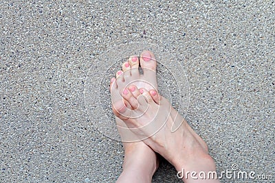 Female Foot Top View. Pink Nail Polish Manicure. Selfie of Woman Bare Feet On Road Background Stock Photo