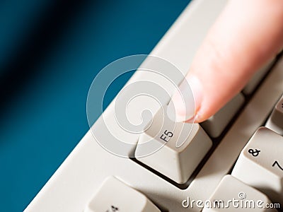 Female forefinger pushes F5 button. Close-up Stock Photo