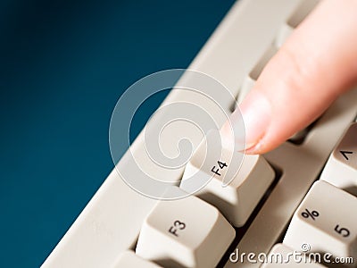 Female forefinger pushes F4 button. Close-up Stock Photo