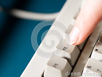 Female forefinger pushes F6 button. Close-up Stock Photo