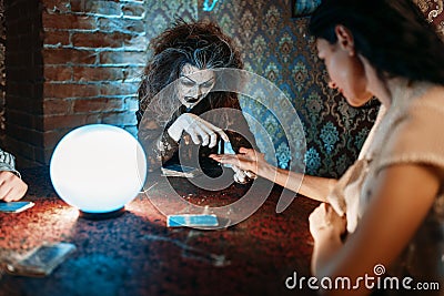 Foreteller guessing by hand over a crystal ball Stock Photo