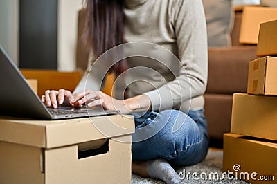 A female freelancer, online shop owner replying her customer question via laptop computer Stock Photo