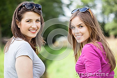 Female friends on a green glade Stock Photo