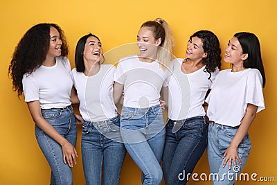 Five Mixed Girls Laughing Posing On Yellow Background In Studio Stock Photo