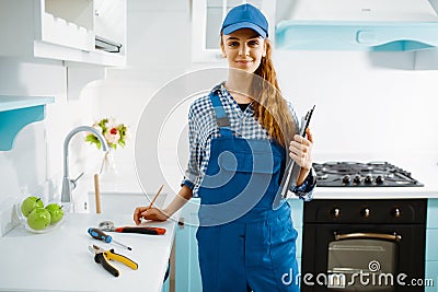 Female furniture maker in uniform holds notebook Stock Photo