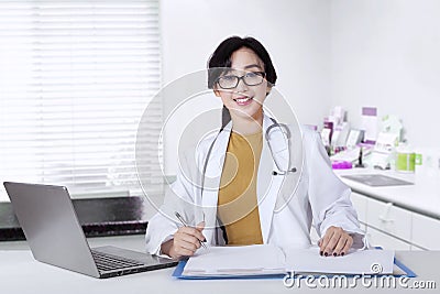 Female general doctor smiling in the office Stock Photo