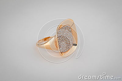 Female, gold glossy ring with diamonds in the middle, isolated on a white background. Stock Photo