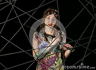 Female gothic warrior in pilot old glasses posing with katana sword Stock Photo