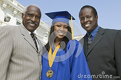 Female Graduate With Father And Brother Stock Photo