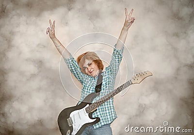 Female guitar player with hands up showing peace sign Stock Photo