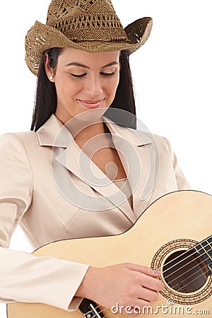 Female guitar player lost in music smiling Stock Photo