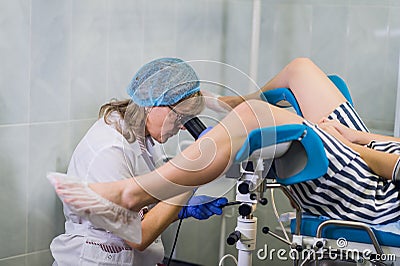 Female Gynecologist During Examination In Her Office Stock Photo