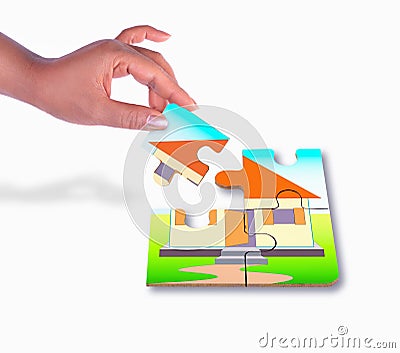 Female hand approaching with a piece of a puzzle to complete jig Stock Photo