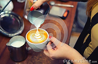 Female hand barista with a white cup of fragrant cappuccino Stock Photo