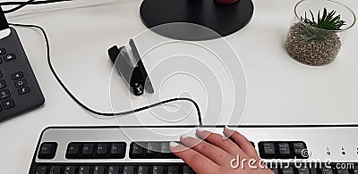 Female hand on black computer keyboard Stock Photo