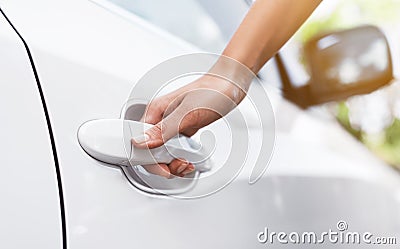 Female hand on the car door handle Stock Photo