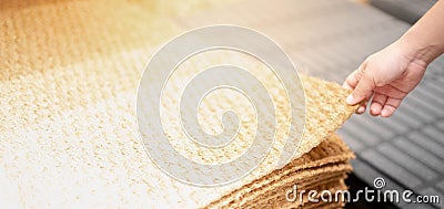 The female hand choosing the rug for use inside the house, The rug in the interior store at the warehouse store Stock Photo