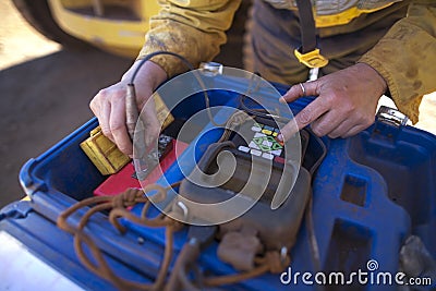 Female hand commencing UT calibration equipment unit prior starting to work Stock Photo