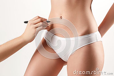 The female hand drawing lines on woman`s abdomen Stock Photo