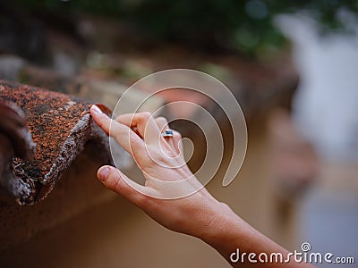 Female hand gently touches weathered tiles Stock Photo