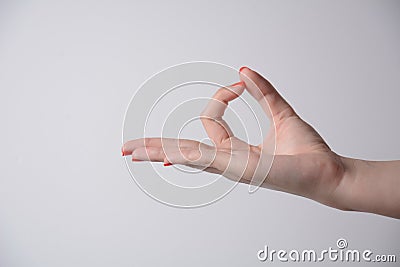 Female hand gesture - ok ,everything is good, right ,zero empty place, worthless, on a gray background Stock Photo