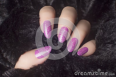 Glittered pink nails manicure Stock Photo