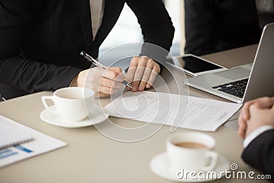 Female hand going to sign document, putting signature, close up Stock Photo