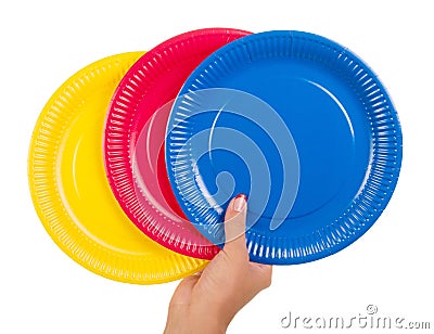 Female hand holding colorful disposable plates isolated on white. Stock Photo