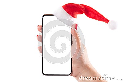 Female hand holding mobile smart phone with santa hat isolated on white background. Blank white screen. Concept of Christmas Stock Photo