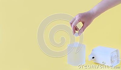 Female hand holding a refill tablet for soap dispencer. automatic foam making device. eco friendly waste reduce cleaning. hand Stock Photo