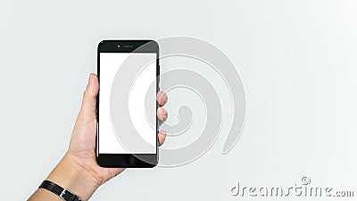 Female hand holding smartphone / mobile cell phone, white background Stock Photo