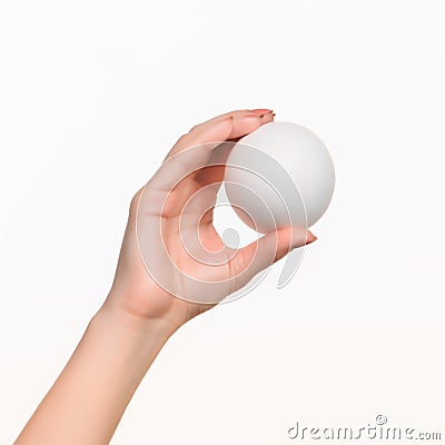 The female hand holding white blank styrofoam ball Stock Photo