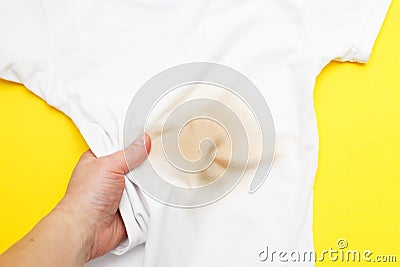 female hand holding white clothes with a dirty stain Stock Photo