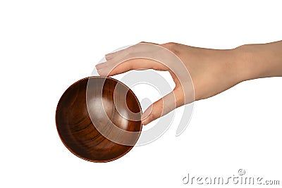 Female hand is holding a wooden bowl isolated on a white background Stock Photo