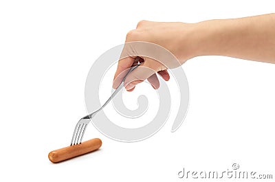 Female hand holds frankfurter sausage on a fork. Isolated on white background Stock Photo